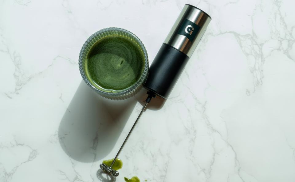 An image of a frother and a glass of greens